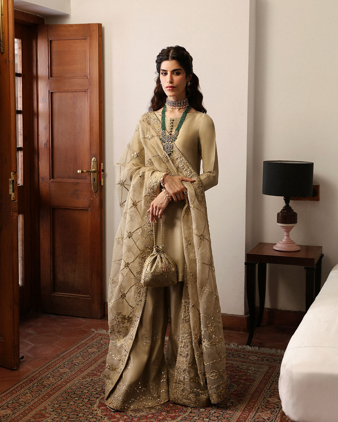 Model Wearing Faiza Saqlain Nainsi Gold Shirt with Flared Pants for formal events wear - Pakistani Designer Wear for Women in UK | Kifat