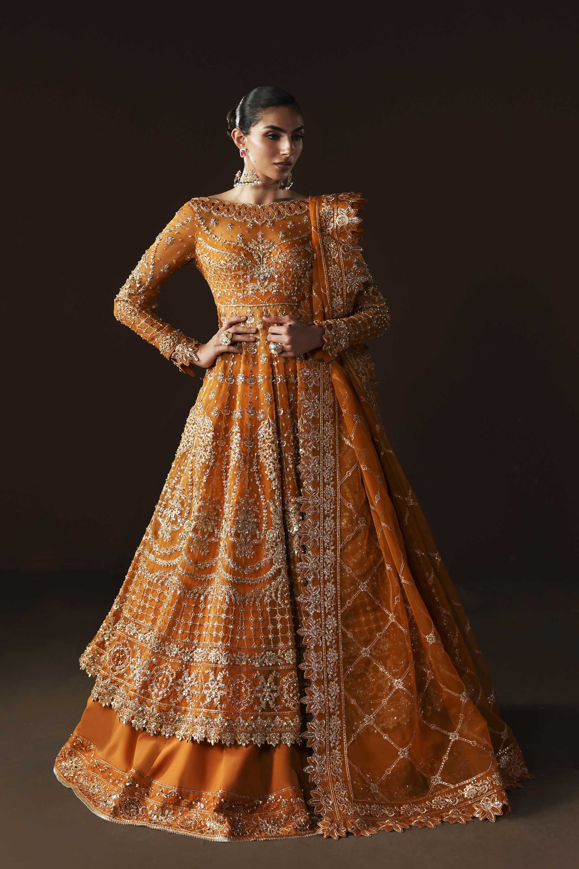 Women Wearing Muselet Orange Peshwas For Luxury Formals Events - Pakistani Designer Wear For Women In UK | Kifat