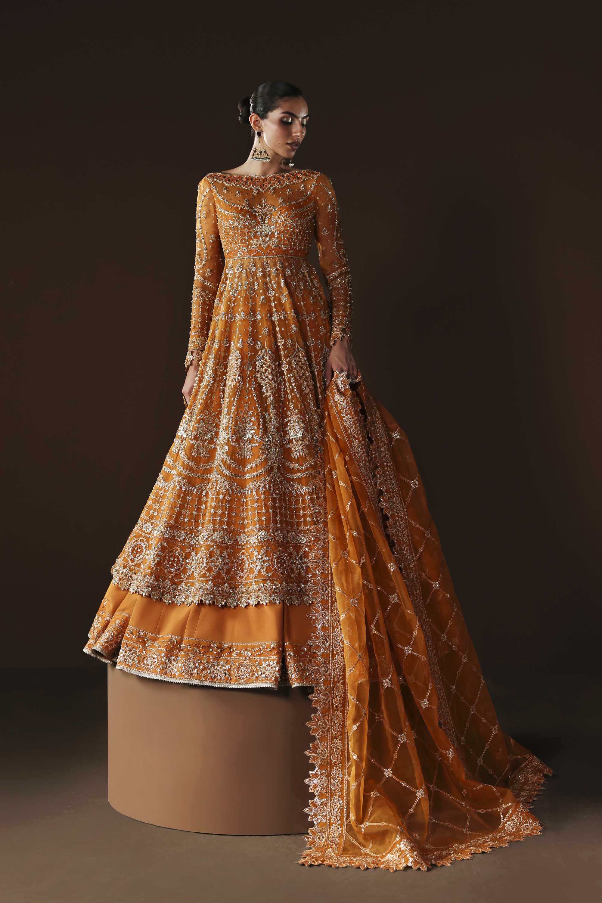 Women Wearing Muselet Orange Peshwas For Luxury Formals Events - Pakistani Designer Wear For Women In UK | Kifat